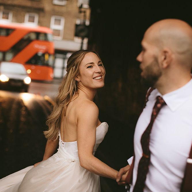 Bride in Bespoke Wedding Gown with Blush Underskirt and One Off Shoulder Strap | Half Up Half Down Bridal Hair | Groom in Grey Puppy Tooth Check Two-Piece Paul Smith Suit with Amber Tie Pin, Pocket Square and Braces | Bike Shed Motorcycle Club Wedding for ELLE Digital Editor | Nigel John Photography