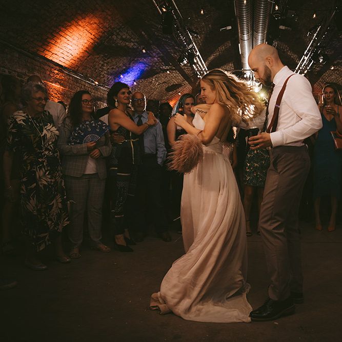 First Dance | Bride in Bespoke Wedding Gown with Blush Underskirt and One Off Shoulder Strap | Half Up Half Down Bridal Hair | Groom in Grey Puppy Tooth Check Two-Piece Paul Smith Suit with Amber Tie Pin, Pocket Square and Braces | Bike Shed Motorcycle Club Wedding for ELLE Digital Editor | Nigel John Photography