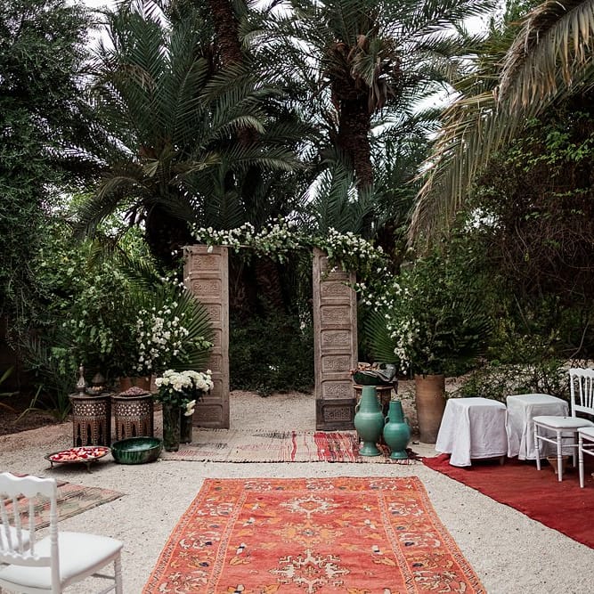 Wooden Door Altar | Moroccan Rugs | Outdoor Ceremony Wedding Decor | Paradise Destination Wedding at Jnane Tamsna in Marrakech, Morocco | Nordica Photography | Matteo Castelluccia Film