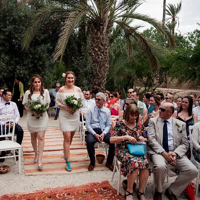 Outdoor Wedding Ceremony | Moroccan Rugs | Bridesmaids in White Vero Moda Dresses |  Paradise Destination Wedding at Jnane Tamsna in Marrakech, Morocco | Nordica Photography | Matteo Castelluccia Film