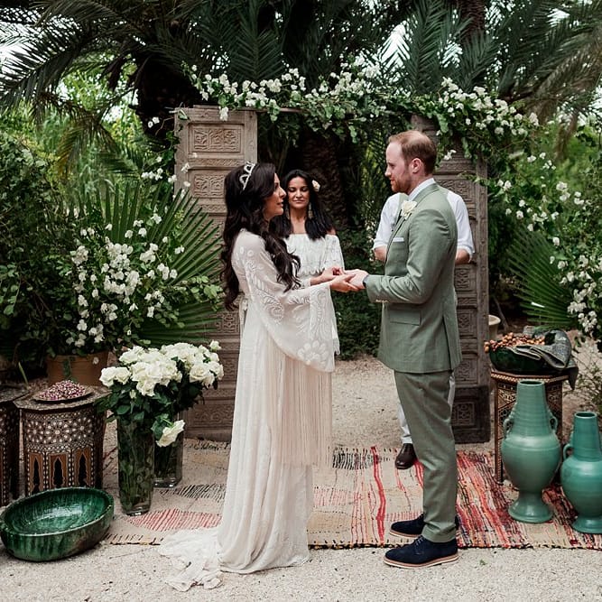 Outdoor Wedding Ceremony | Moroccan Rugs, Wooden Door Altar Wedding Decor | Bride in Rue de Seine Bridal Gown | Groom in Green Beggars Run Suit | Paradise Destination Wedding at Jnane Tamsna in Marrakech, Morocco | Nordica Photography | Matteo Castelluccia Film