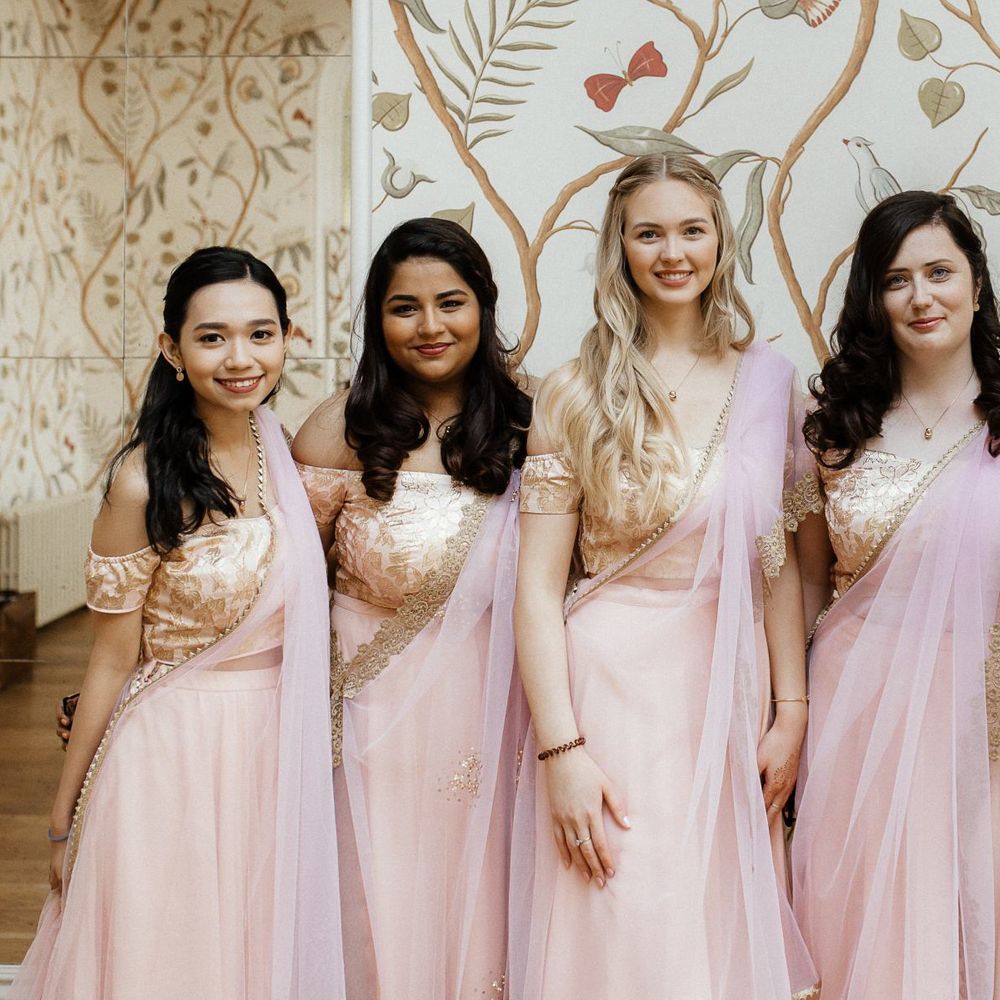 Pink sari for bridal party and navy Indian wedding dress for bride