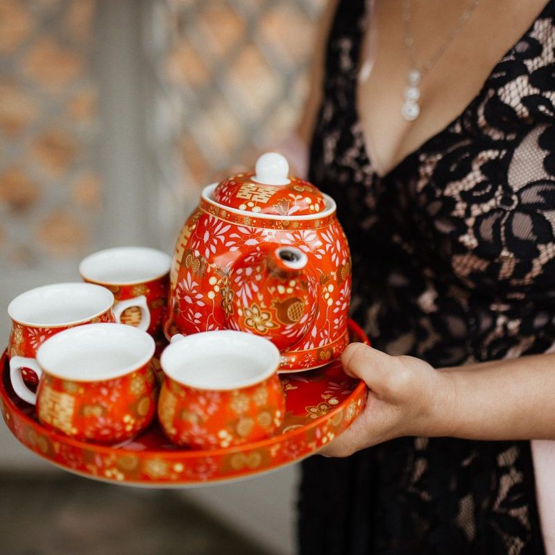 Traditional Chinese tea ceremony for fusion wedding with Indian wedding dress