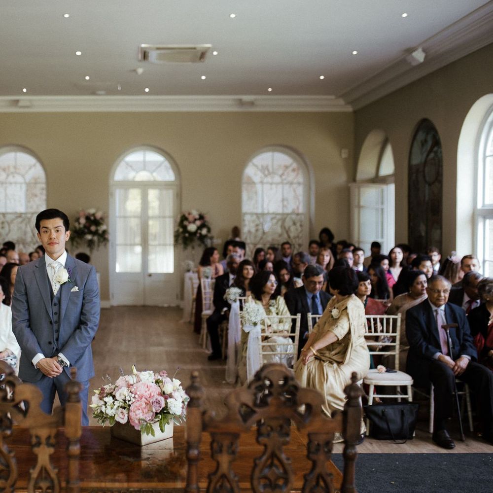 Groom waits for bride at ceremony