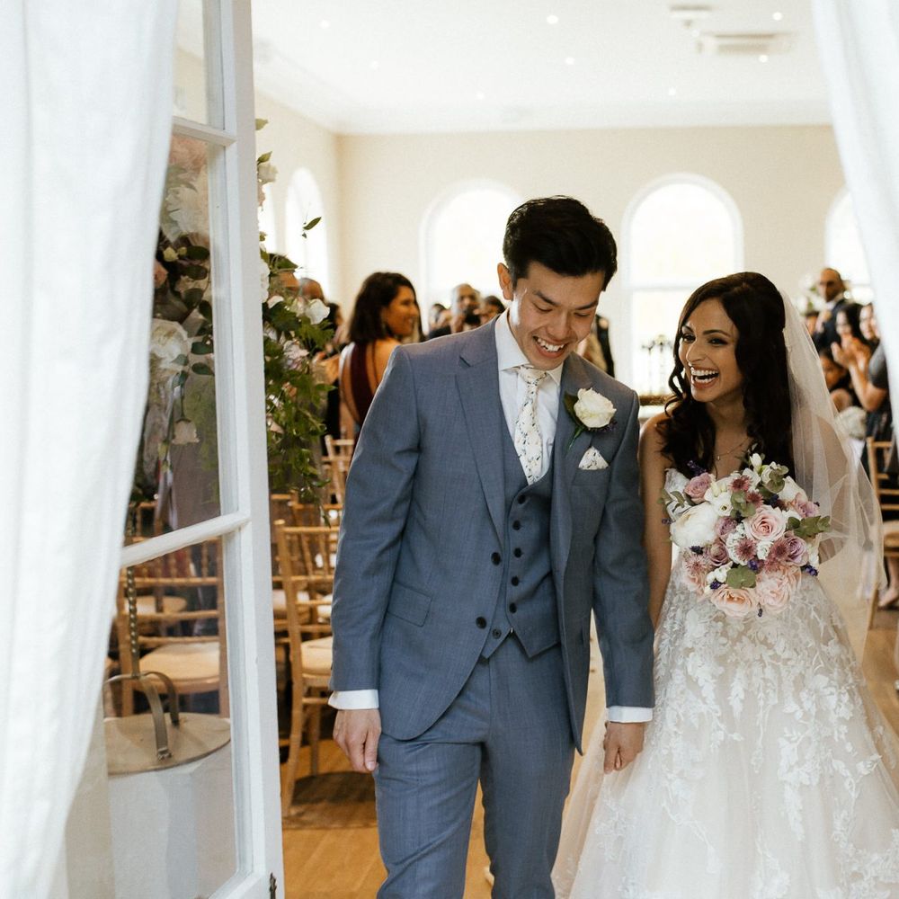 Bride and groom emerge from ceremony as husband and wife