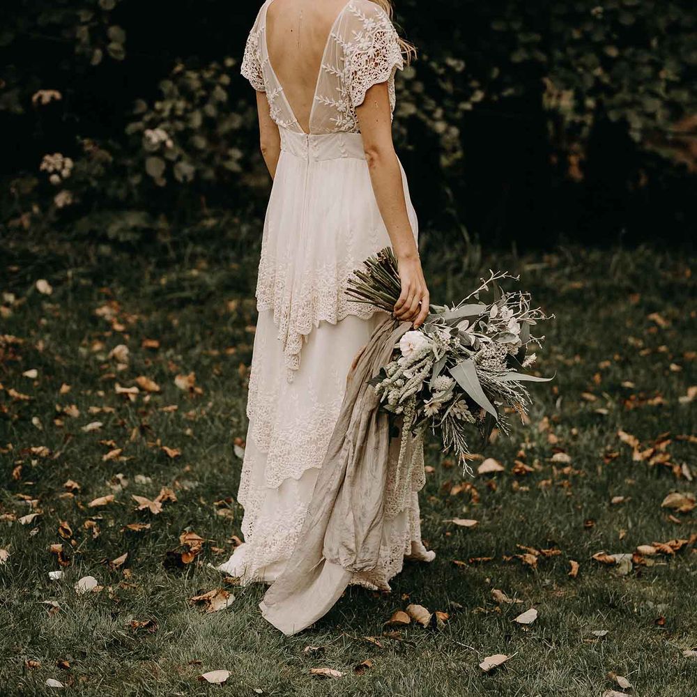 Boho Bride in Lade Wedding Dress &amp; Oversized Bridal Bouquet with Ribbon &amp; Foliage | Nude Bohemian Wedding Inspiration by Wonderland Invites &amp; Rock The Day Styling | Kelsie Low Photography