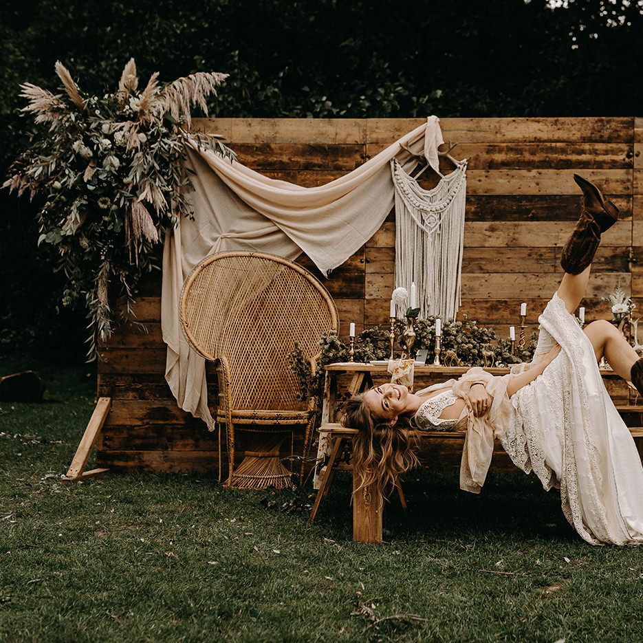 Boho Bride in Lace Wedding Dress | Wooden Backdrop with Drapes, Dried Flowers &amp; Macrame Decor | Wooden Table with Candle Sticks &amp; Greenery Garland | Nude Bohemian Wedding Inspiration by Wonderland Invites &amp; Rock The Day Styling | Kelsie Low Photography