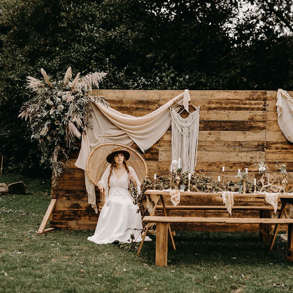 Boho Bride in Lace Wedding Dress | Wooden Backdrop with Drapes, Dried Flowers &amp; Macrame Decor | Wooden Table with Candle Sticks &amp; Greenery Garland | Nude Bohemian Wedding Inspiration by Wonderland Invites &amp; Rock The Day Styling | Kelsie Low Photography