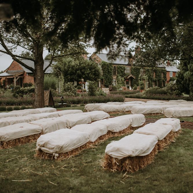 Hay bale seating at home using garden for wedding ceremony
