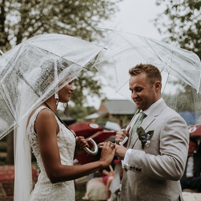 Bride and groom exchanging rings at home garden wedding