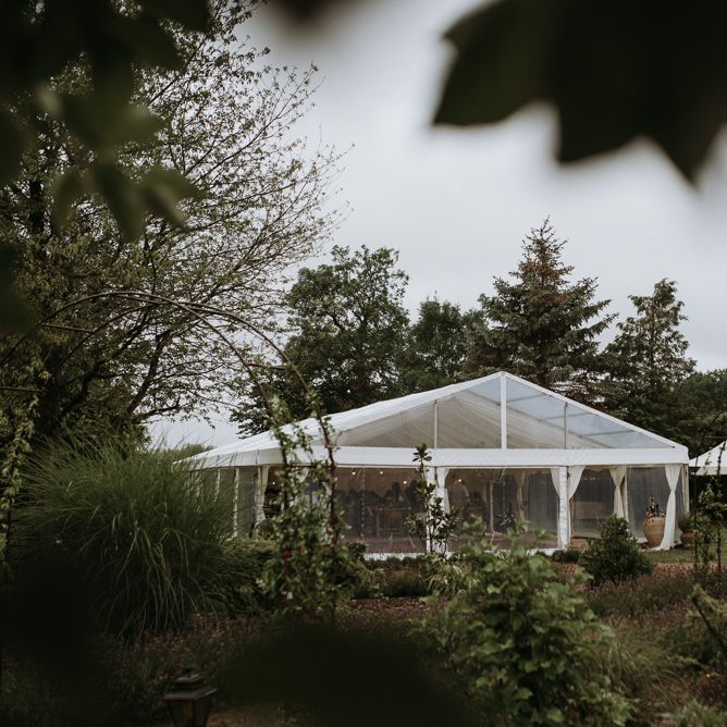 Clear span marquee reception in home garden for wedding celebration