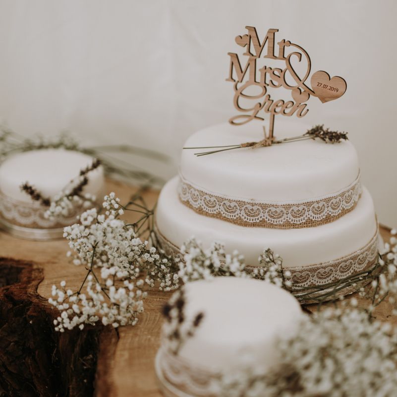 Wedding cake with burlap and lace decor in garden for wedding celebration