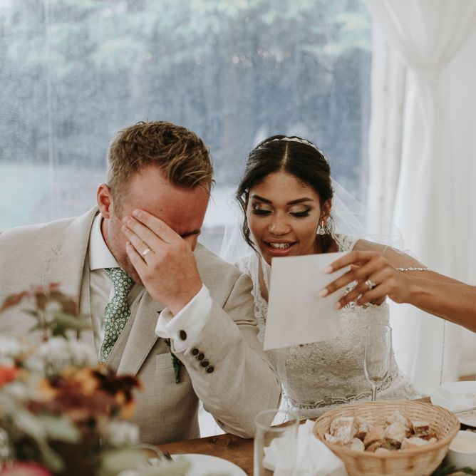 Bride and groom during wedding reception speeches