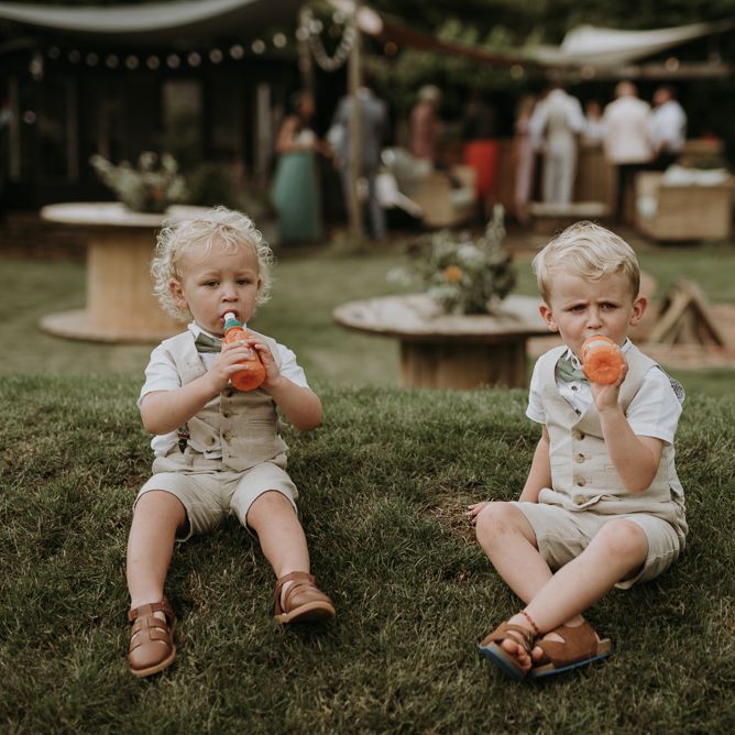 page boys drinking juice in the garden