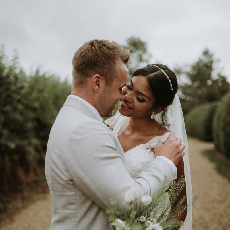 Intimate bride and groom portrait with wildflower bouquet