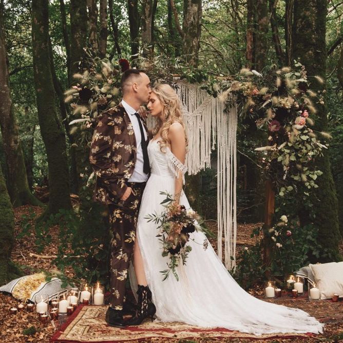 Groom in Brown Patterned Suit and Bride  Cold Shoulder Wedding Dress with Fringe Detail
