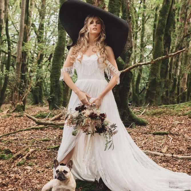 Boho Bride in Lace Wedding Dress with Giant Hat and Pet Pug