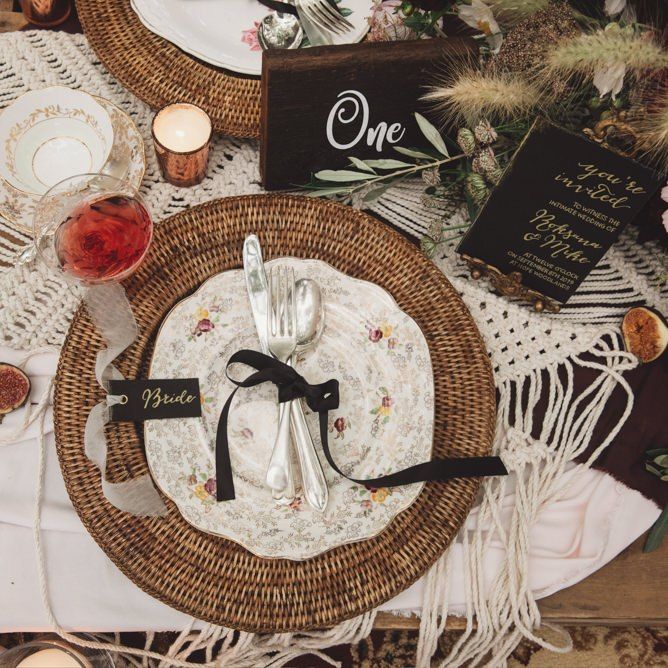 Place Setting with Wicker Place Mat, Floral Plate and Cutlery Tied with Ribbon