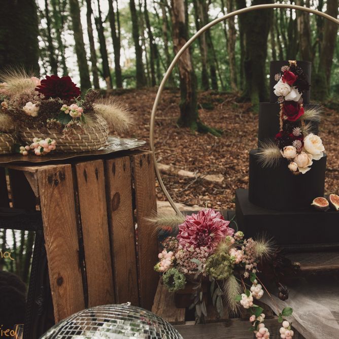 Black Wedding Cake with Flower Decor on Hoop Cake Stand