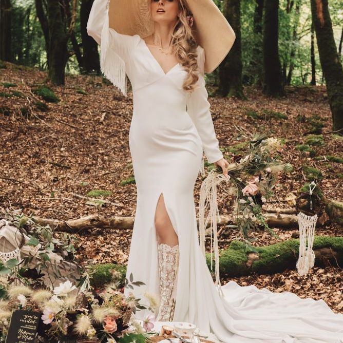 Bride in Fitted Wedding Dress with Fringe Detail and Giant Straw Hat