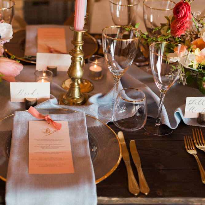 Elegant Place Setting with Gold Rimmed Platter, Blue Linen Napkin and Gold Cutlery