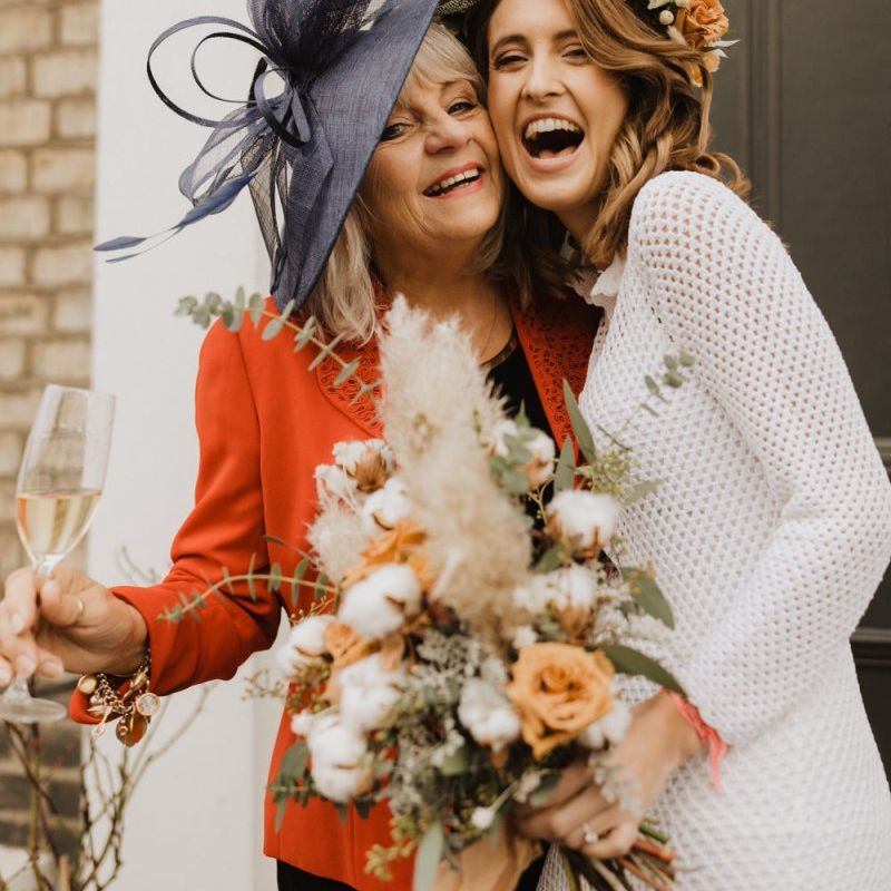 Bride at London wedding wearing vintage dress and floral crown of roses and cotton flowers