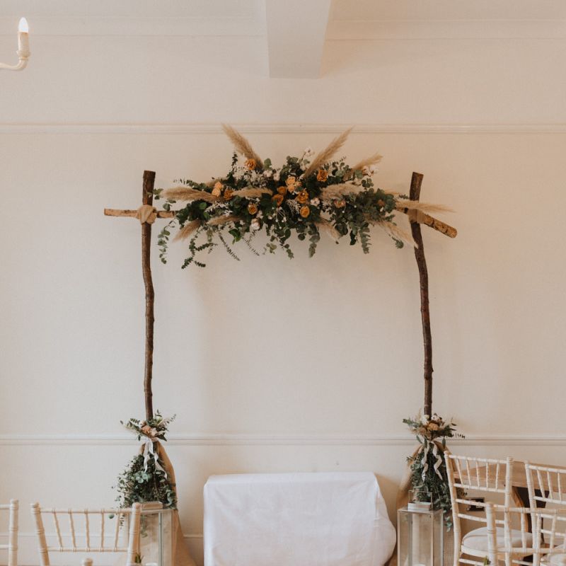 Modern boho aisle decor at Linden House with neutral flowers and candle lanterns