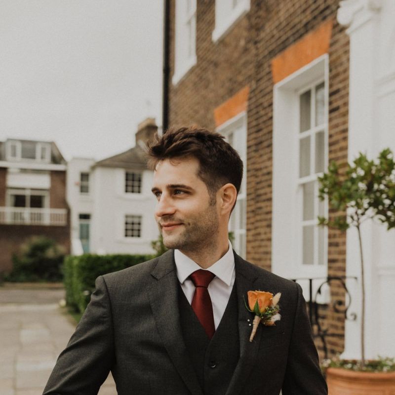 Groom wearing three piece suit and rose buttonhole at intimate wedding in London