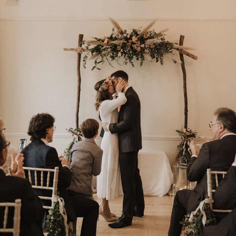 Couple say 'I do' at Linden House wedding with modern style boho decor