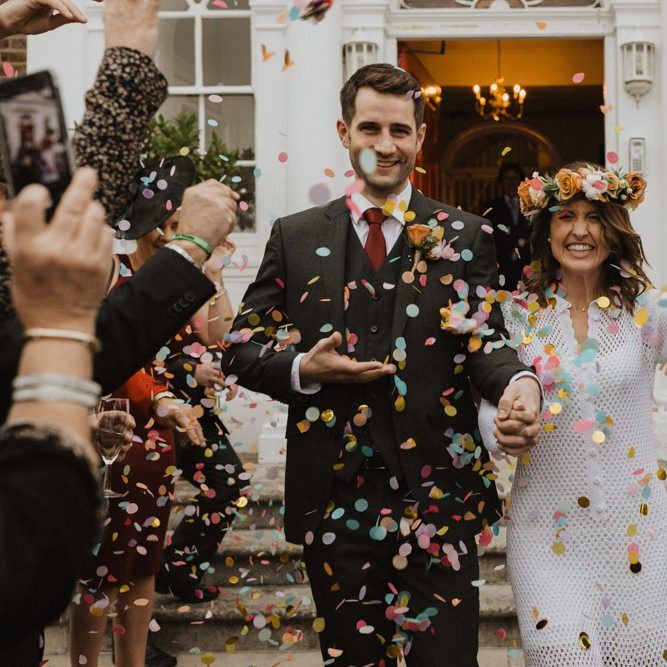Confetti shot at Linden House intimate ceremony with bride wearing beautiful flower crown and vintage dress