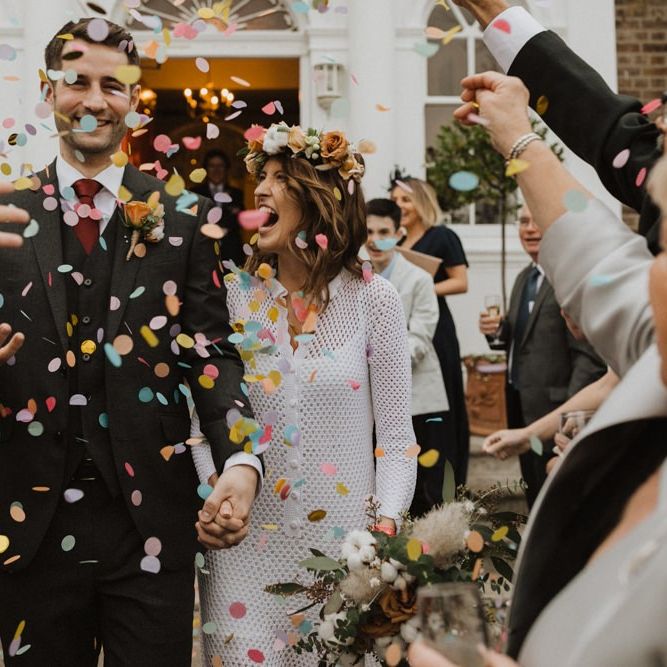 Confetti shot at Linden House intimate ceremony with bride wearing beautiful flower crown and vintage dress
