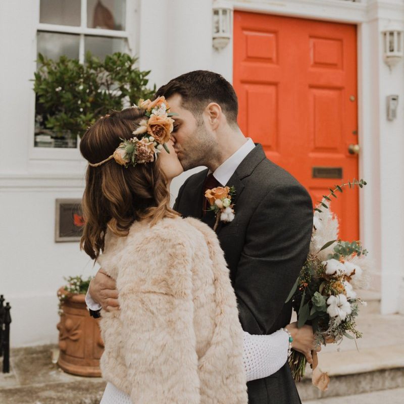 Bride wearing faux fur jacket and floral crown at Linden House wedding ceremony