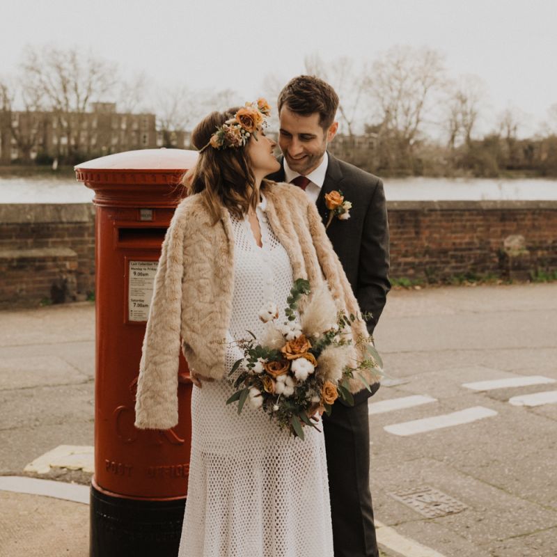 Bride and Groom steal a moment at London wedding wearing vintage dress and flower crown