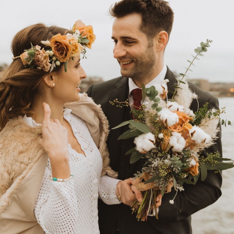 Rose and cotton flower details at London wedding with floral crown and faux fur bomber