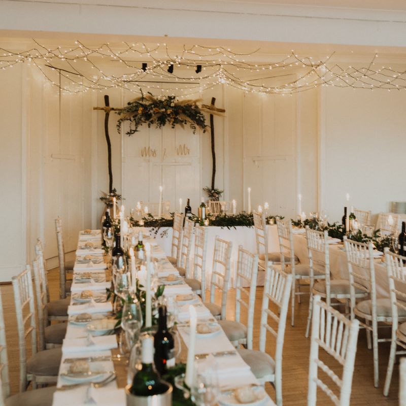 Festoon lighting and floral decor for a relaxed reception dinner at Linden House