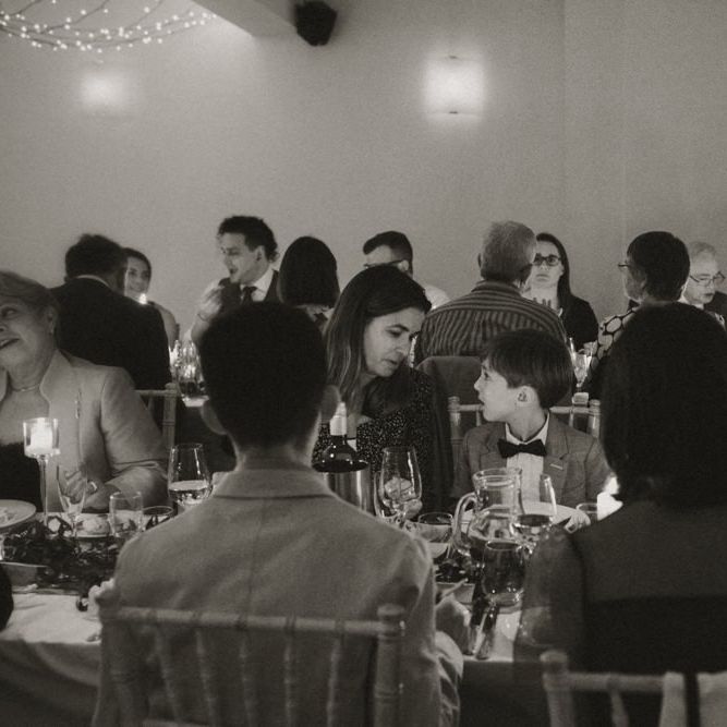 Guests enjoying intimate wedding at Linden House with festoon lighting and floral decor