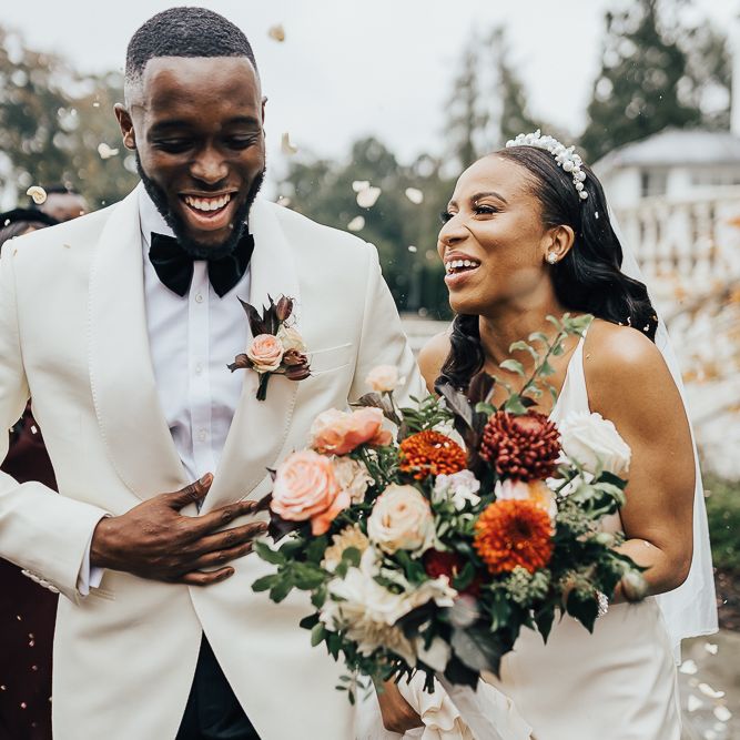 Bride and groom laughing during confetti capture at Coworth Park