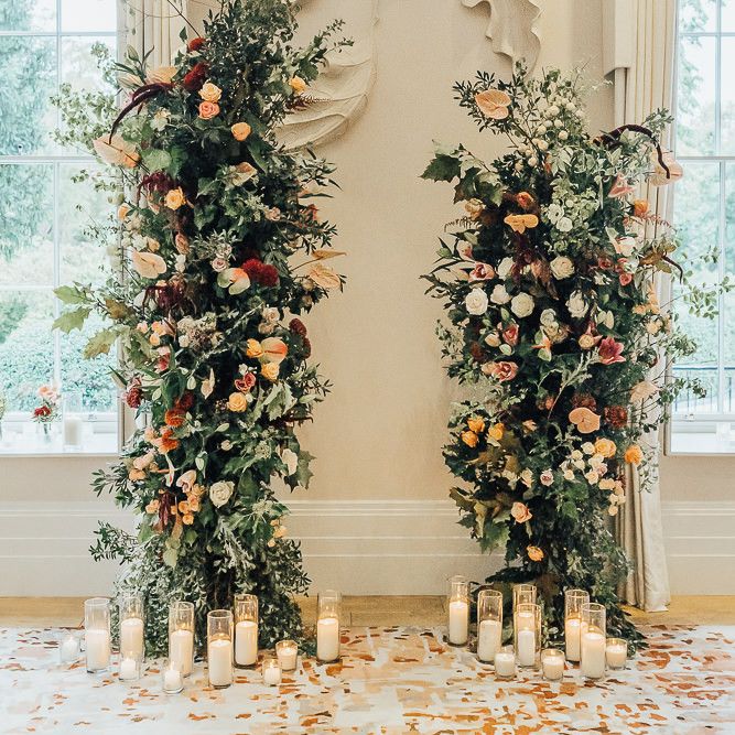 Altar at Coworth Park with vertical floral arrangements and candles