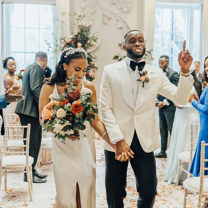 Stylish bride and groom descending up the aisle as husband and wife