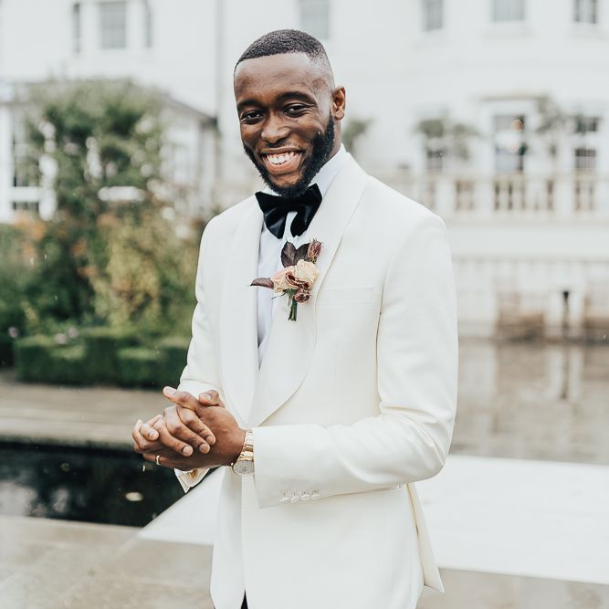 Stylish groom in white blazer for black-tie wedding
