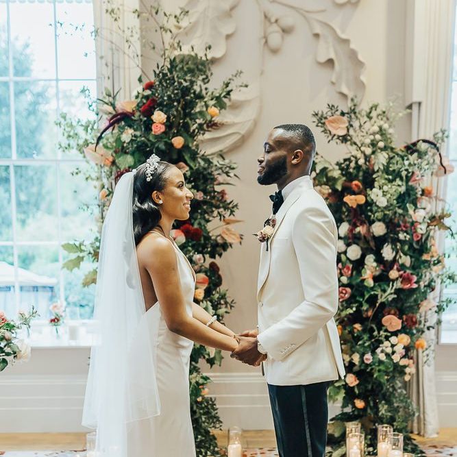 Bride and groom exchanging vows at intimate Coworth Park wedding ceremony