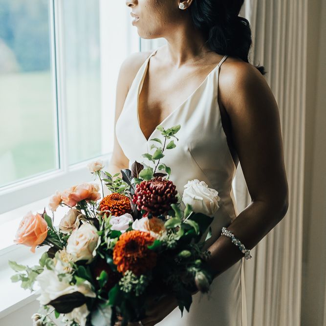 Beautiful bride in strappy wedding dress and pearl headdress