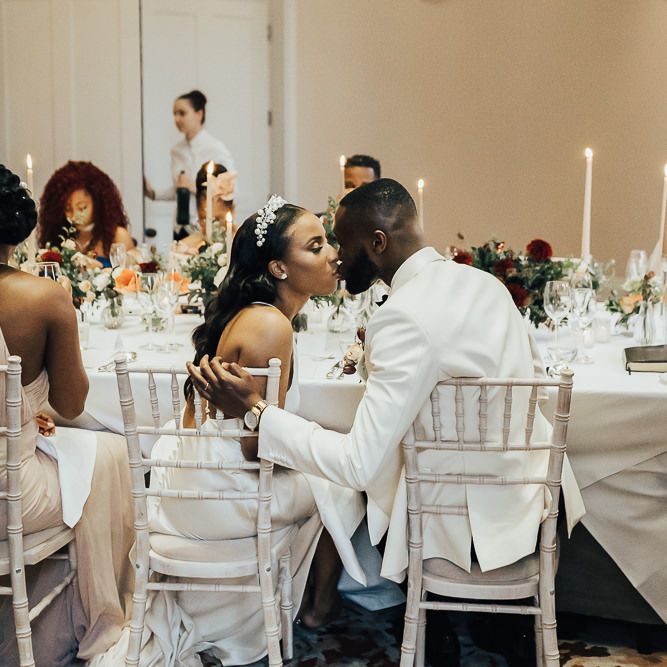 Bride and groom kissing at Coworth Park reception
