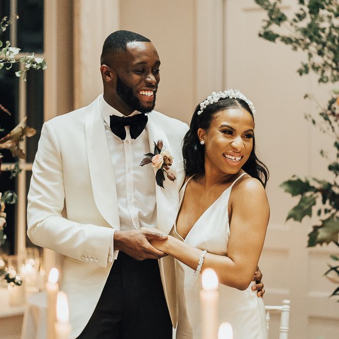 Bride and groom embracing during wedding speeches at Coworth Park