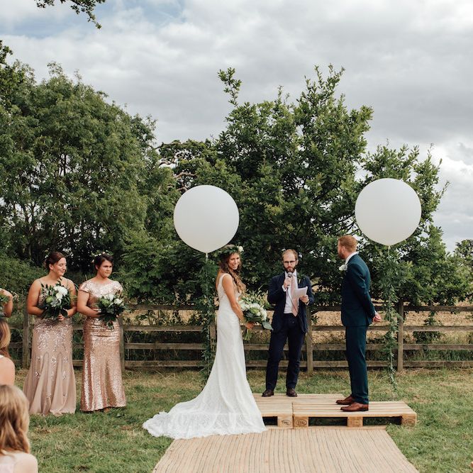 Wedding Ceremony | Giant Balloon Decor | Bride in La Sposa Gown from Mirror Mirror Bridal | Groom in Paul Smith Suit | Outdoor Wedding Ceremony &amp; Tipi Reception Planned by Benessamy Events | Red on Blonde Photography