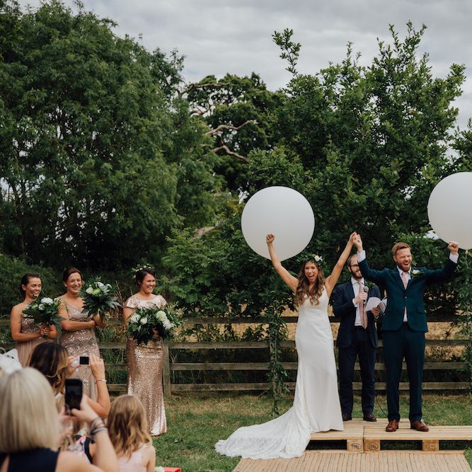Wedding Ceremony | Giant Balloon Decor | Bride in La Sposa Gown from Mirror Mirror Bridal | Groom in Paul Smith Suit | Outdoor Wedding Ceremony &amp; Tipi Reception Planned by Benessamy Events | Red on Blonde Photography