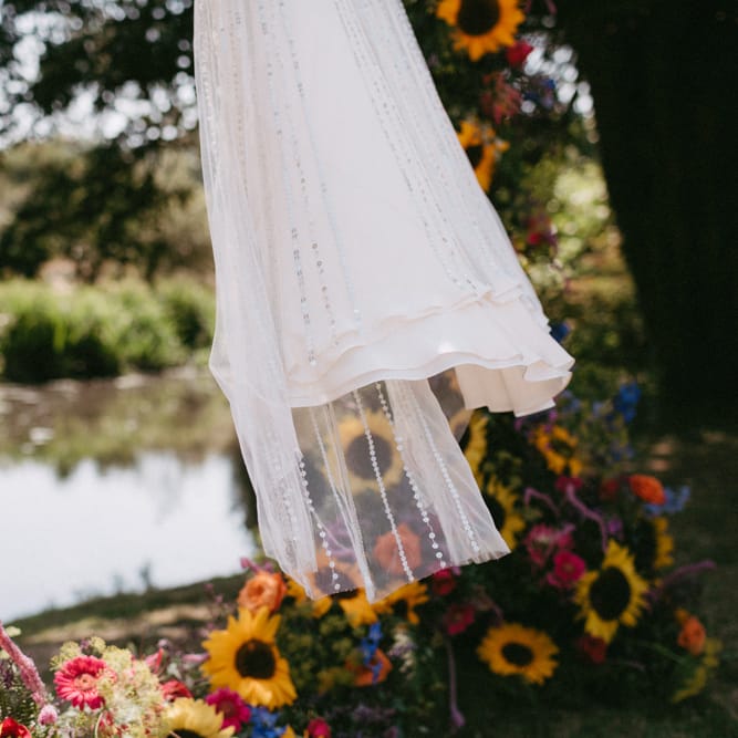 Jenny Packham Portia Wedding Dress Hanging Up in Sunflower Moon Gate