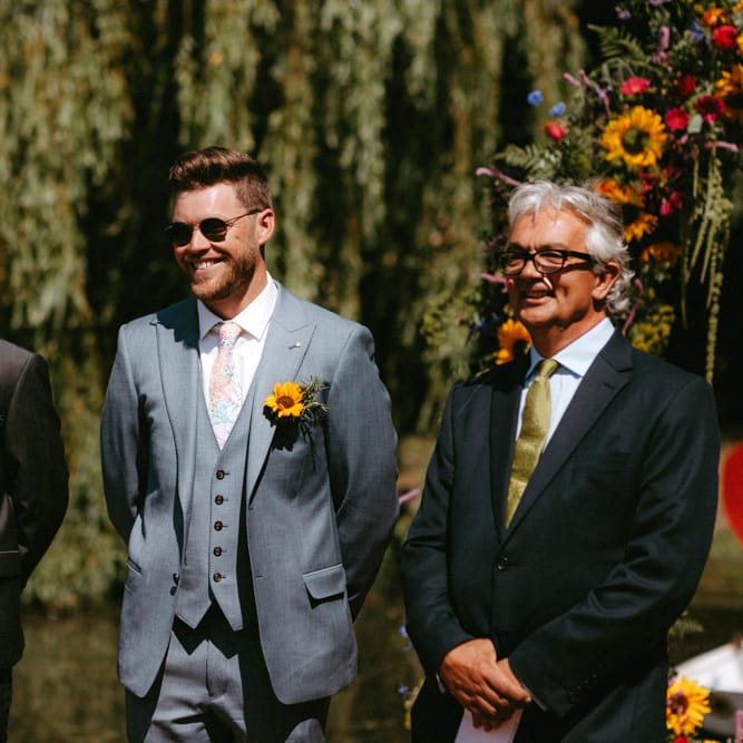 Groomsmen in Ted Baker Suits and sunflower Buttonhole Standing at the Altar