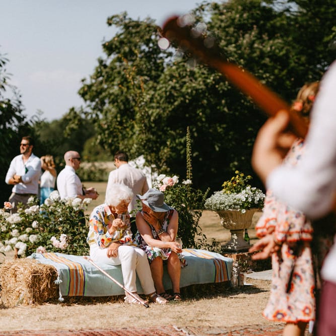 Wedding Guests Sitting on Hay Bales