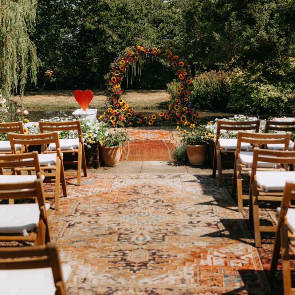 Outdoor Wedding with Persian Rugs and Sunflower Moongate